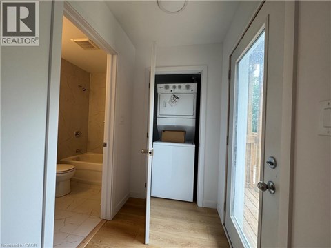 A white refrigerator is in a kitchen with a door open.