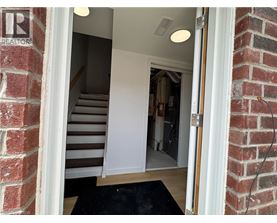 A doorway with a mat on the floor leading to a hallway.
