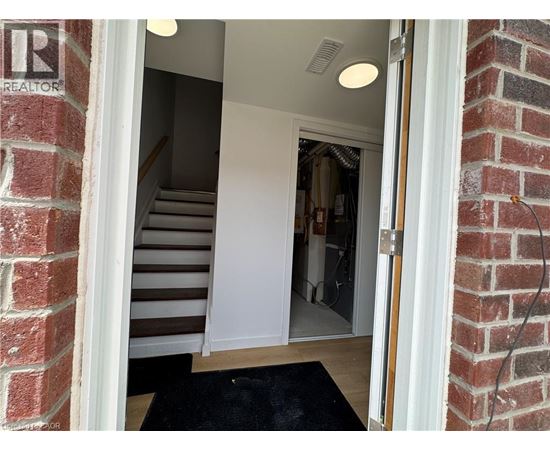 A doorway with a mat on the floor leading to a hallway.