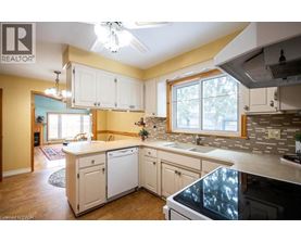 A kitchen with white cabinets and a large island.