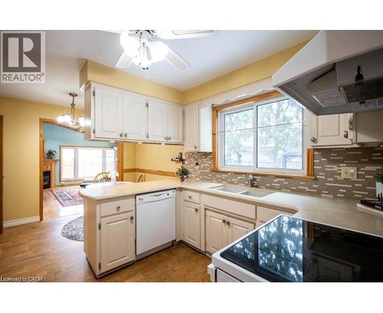 A kitchen with white cabinets and a large island.