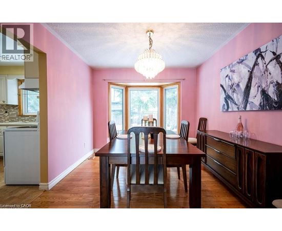 A dining room with a wooden table and chairs.