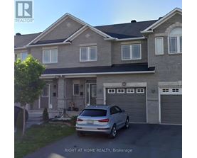 A house with a car parked in front of it.
