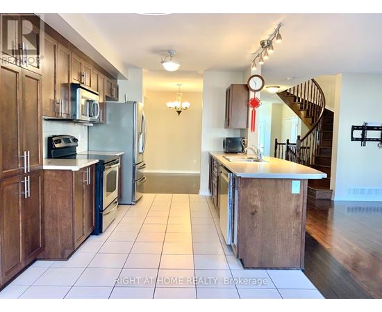 A kitchen with wooden cabinets and a white refrigerator.
