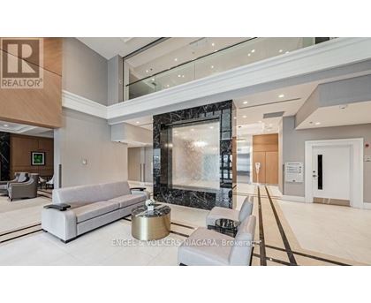 A modern living room with a marble fountain and a large mirror.