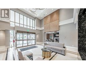 A spacious living room with a grey sofa and a coffee table.