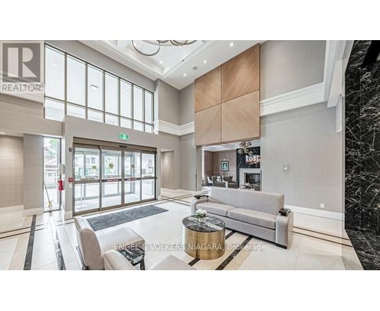 A spacious living room with a grey sofa and a coffee table.
