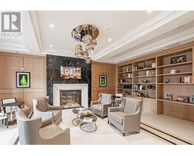 A living room with a fireplace and a bookshelf.