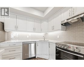 A kitchen with white cabinets and a stainless steel dishwasher.
