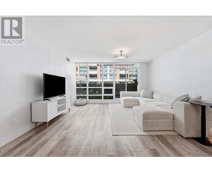 A living room with a television and a couch.