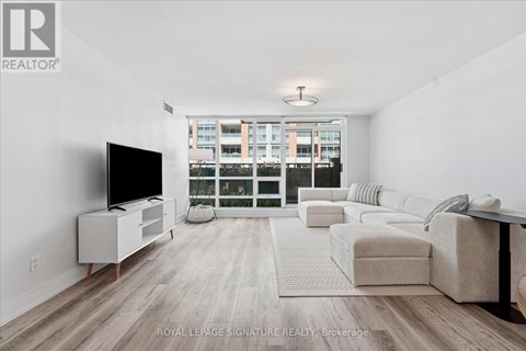 A living room with a television and a couch.