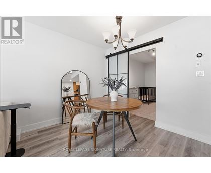 A dining room with a round table and chairs.