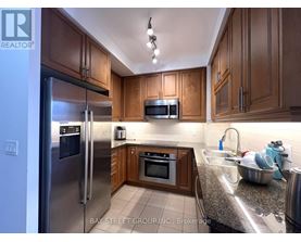 A kitchen with wooden cabinets and stainless steel appliances.