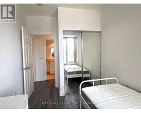 A bedroom with a bed and a mirror on the wall.