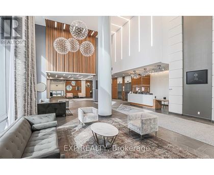 A modern living room with a grey sofa and a white coffee table.