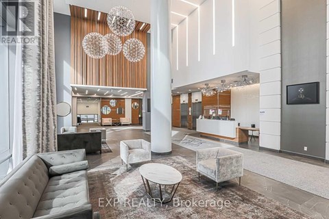 A modern living room with a grey sofa and a white coffee table.