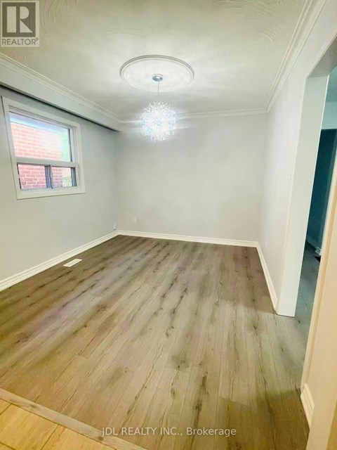 A room with wooden flooring and a window.