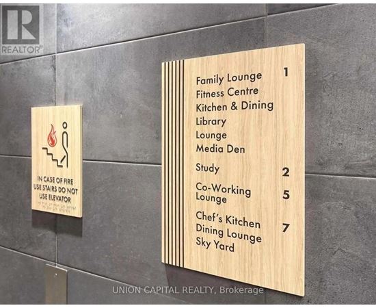 A wooden sign lists the locations of the lounges and studys in a building.