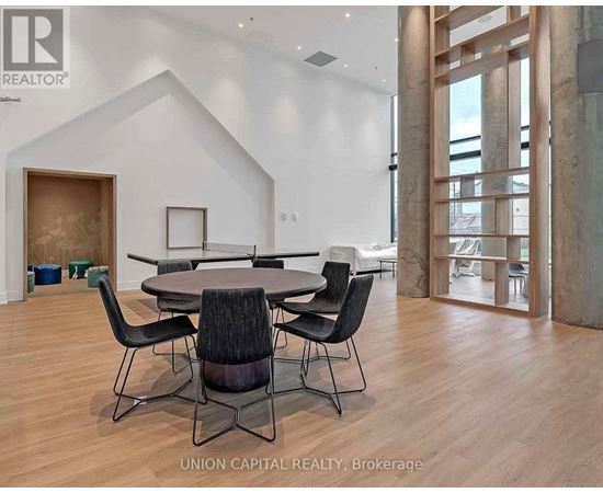A dining room with a table and chairs.