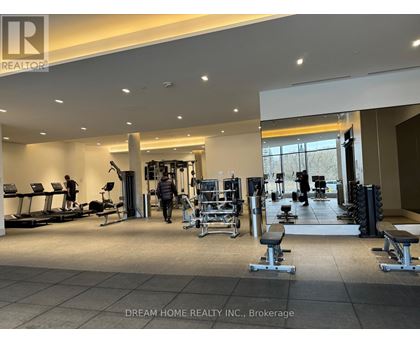 A gym with a variety of equipment including treadmills, weights, and exercise machines.