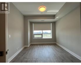 A room with a window and wooden floors.