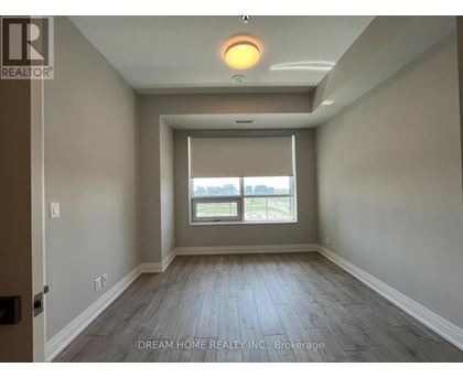 A room with a window and wooden floors.