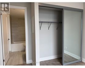 A glass door closet with a white door and a white wall.