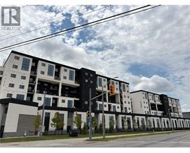 A modern apartment building with a black and white facade.