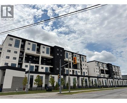 A modern apartment building with a black and white facade.