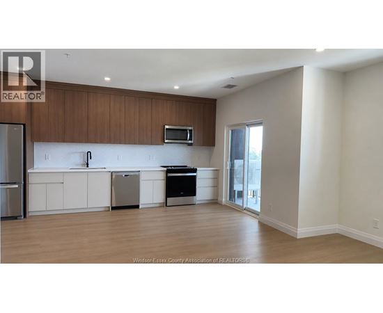 A kitchen with white cabinets and a black dishwasher.