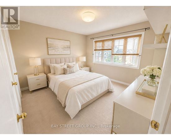 A bedroom with a large bed and a window with blinds.
