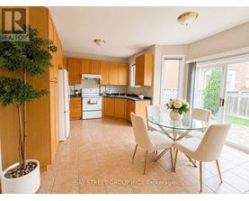 A kitchen with a glass table and chairs.