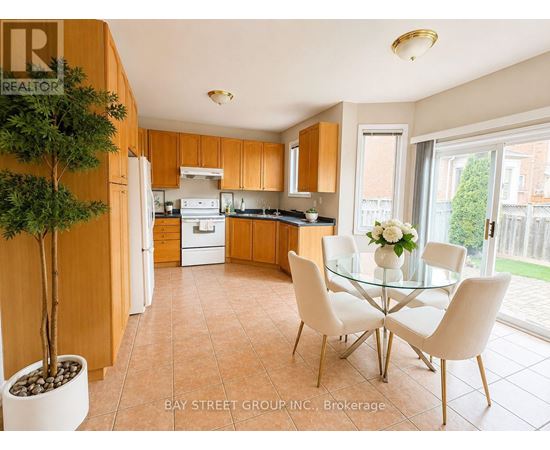 A kitchen with a glass table and chairs.