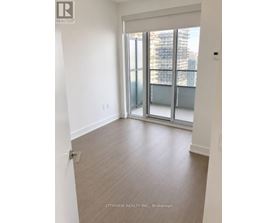 A room with a sliding glass door leading to a balcony.