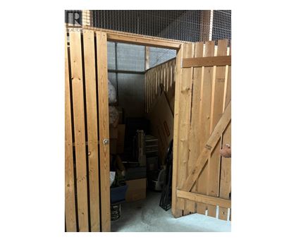 A wooden door is open to a storage room.