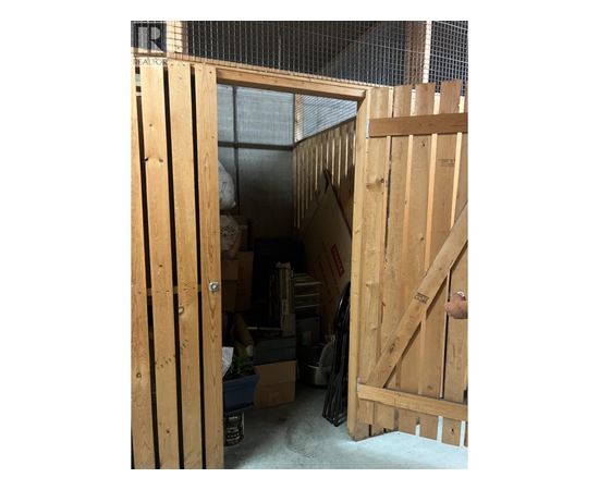 A wooden door is open to a storage room.