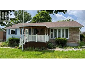 A small house with a porch and a white railing.