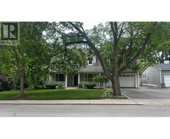 A house with a green tree in front of it.