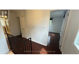 A room with white walls and a wooden floor.