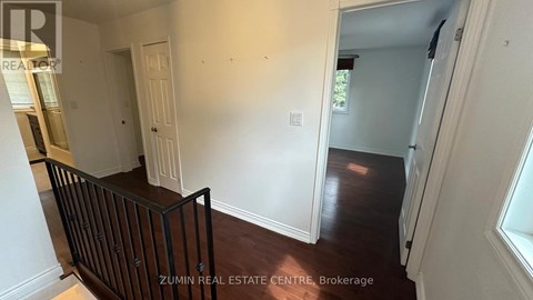 A room with white walls and a wooden floor.
