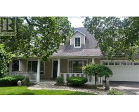 A house with a grey roof and a white garage door.