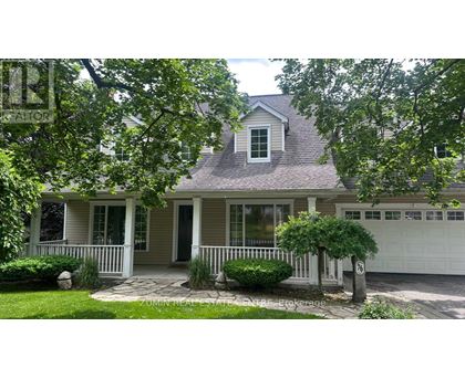 A house with a grey roof and a white garage door.