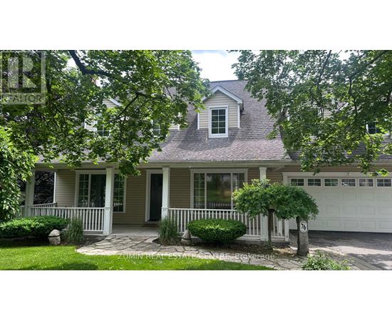 A house with a grey roof and a white garage door.