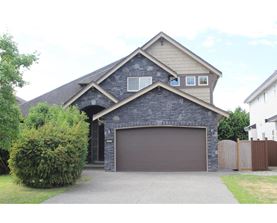 A house with a garage and a driveway.
