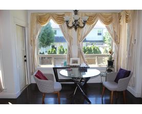 A dining room with a table and chairs.