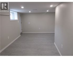 A spacious room with a grey carpet and white walls.
