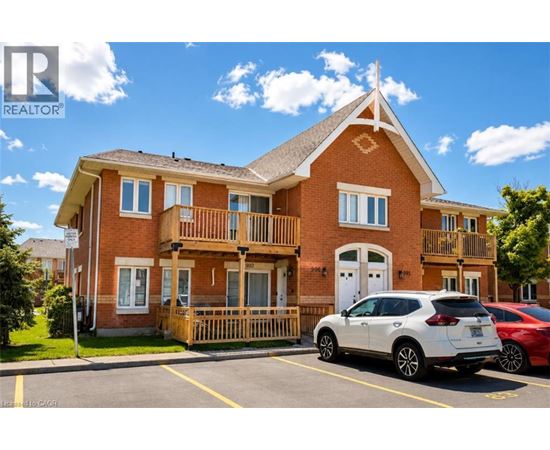 A white car is parked in front of a red brick house.
