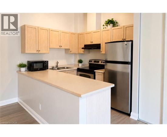 A kitchen with wooden cabinets and stainless steel appliances.