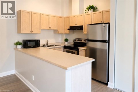 A kitchen with wooden cabinets and stainless steel appliances.