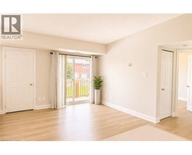 A room with a sliding glass door leading to a balcony.